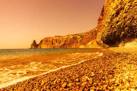 Abstract nature summer ocean sunset sea background. Small waves on water surface in motion blur with bokeh lights from sunrise. Holiday, vacation and recreational background conceptの写真素材