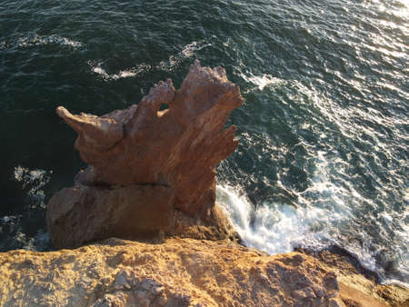 Dragon head arise from the water - The rock or lava formation with the shape of a large animal. Popular travel destination volcanic rock formation in the shape of a dragons head.の写真素材