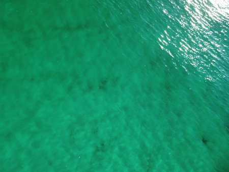 Aerial panoramic view of seascape with crystal clear azure sea and rocky shores. Yachts in a beautiful lagoon on backdrop of rocks. The concept of an ideal destination for summer travel and vacation.の写真素材