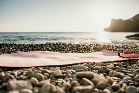 Pilates magic ring and rubber ball on yoga mat near sea. Female fitness yoga concept. Healthy lifestyle harmony and meditation.の写真素材