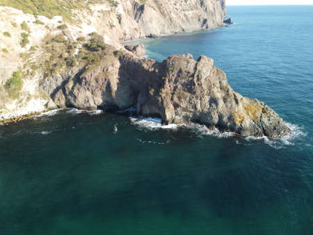 Aerial panoramic view of seascape with crystal clear azure sea and rocky shores. Yachts in a beautiful lagoon on backdrop of rocks. The concept of an ideal destination for summer travel and vacation.の写真素材