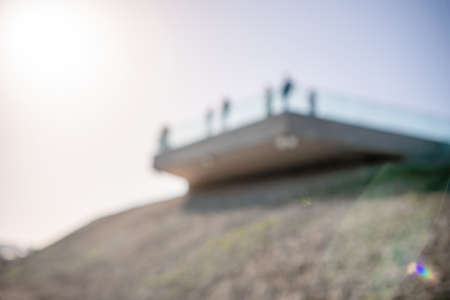 Abstract selective focus glass fence in the seaside park. a popular viewpoint, admiring the natural beauty of the sunset. An observation deck with a figured fence and a lantern. City architecture.の写真素材