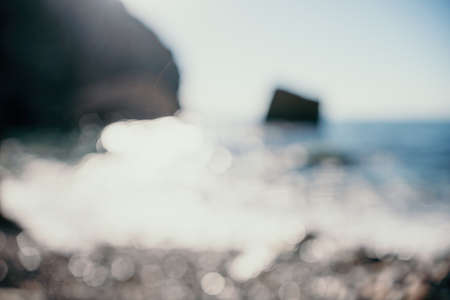 Abstract nature summer ocean sunset sea background. Small waves on water surface in motion blur with...
