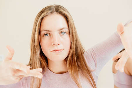 Portrait of young sporty woman, fitness instructor in pink sportswear doing stretching and pilates...