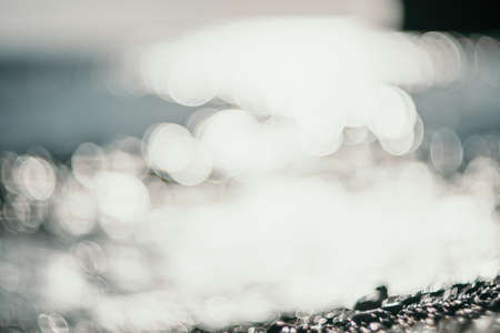 Abstract nature summer ocean sunset sea background. Small waves on water surface in motion blur with...