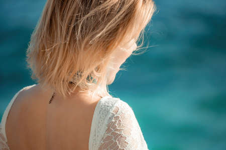 Woman in bohemian clothing on beach at sunset. Boho style for fashionable look on resort. Middle...