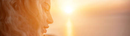 Womens eyes banner. Close up portrait of curly redhead young caucasian woman with freckles at sunset time and sea background. Cute woman portrait.の写真素材