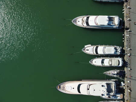 Aerial panoramic view of Balaklava landscape with boats and sea in marina bay. Crimea Sevastopol tourist attraction. Drone top view shot of port for luxury yachts, boats and sailboats.の写真素材