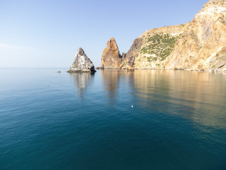 Aerial panoramic view of seascape with crystal clear azure sea and rocky shores. Yachts in a beautiful lagoon on backdrop of rocks. The concept of an ideal destination for summer travel and vacation.の写真素材
