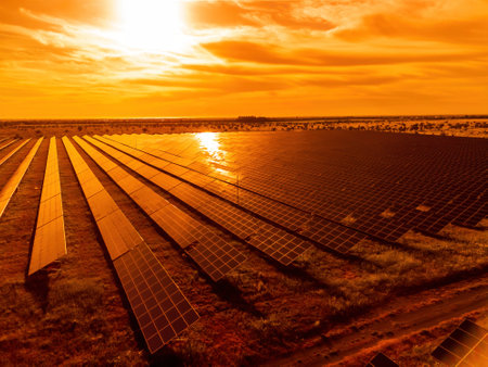 Aerial top view of a solar panels power plant. Photovoltaic solar panels at sunrise and sunset in...