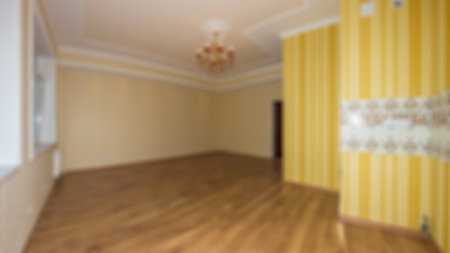 Empty bright room, wooden floor in new apartment. Defocused and Blured bright empty room without furniture for show, promote and design content or product on display conceptの写真素材