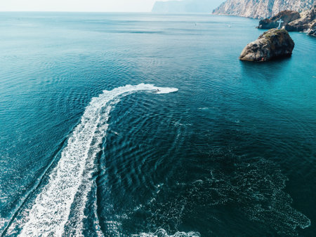 High speed water bike leaving abstract white footprints on the sea water. Aerial top view on Water scooter. Amazing nature background. Water color are beautifully vibrant. Fresh freedom. Adventure dayの写真素材
