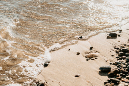 Abstract sea summer ocean sunset nature background. Small waves on golden water surface in motion...