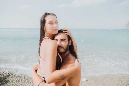 Woman man sea sup. Close up portrait of happy young caucasian woman with black hair and freckles looking at camera and smiling. Cute woman portrait in a pink bikini posing on sup board in the seaの写真素材