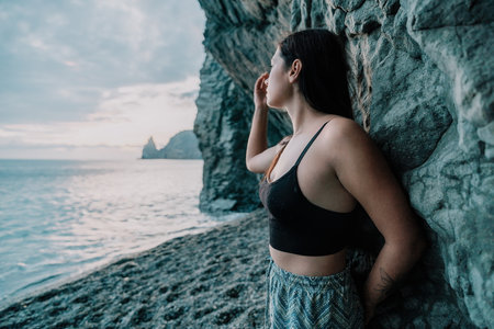 Portrait of cheerful female climber resting on a volcanic basalt