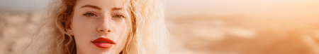 Womens eyes banner. Close up portrait of curly redhead young caucasian woman with freckles at sunset...