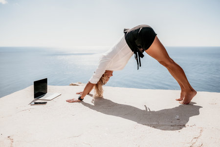 Woman sea laptop yoga. Business woman freelancer in yoga pose working over blue sea beach at laptop...