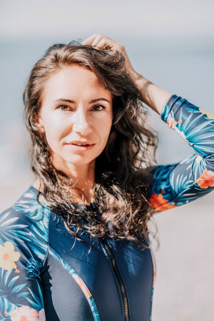 Portrait woman sea. Well looking middle aged woman with black hair, fitness instructor in blue...