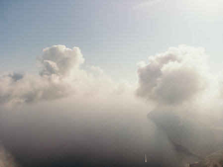 Blue sky with white clouds over calm summer panorama of the sea. Drone aerial view. Abstract aerial nature summer ocean sunset sea and sky background. Horizon. No people. Holiday and vacation conceptの写真素材