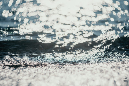 Abstract sea summer ocean sunset nature background. Small waves on golden water surface in motion...