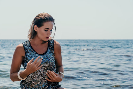Woman summer travel sea. Happy tourist enjoy taking picture outdoors for memories. Woman traveler posing on the beach at sea surrounded by volcanic mountains, sharing travel adventure journeyの写真素材