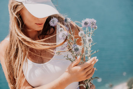 Woman summer travel sea. Happy tourist enjoy taking picture outdoors for memories. Woman traveler posing over sea bay surrounded by volcanic mountains, sharing travel adventure journeyの写真素材