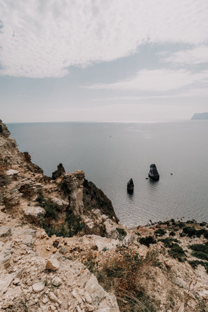 Aerial view from above on calm azure sea and volcanic rocky shores. Small waves on water surface in motion blur. Nature summer ocean sea beach background. Nobody. Holiday, vacation and travel conceptの写真素材