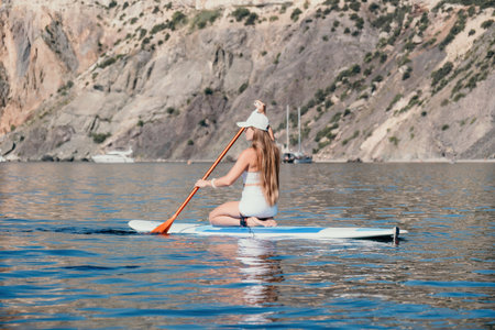 Woman sea sup. Close up portrait of happy young caucasian woman with long hair looking at camera and...