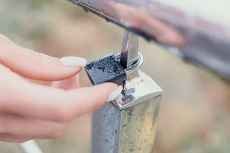 Wedding heart golden lock on stainless iron fence valentines day symbol of eternal love a weddingの写真素材
