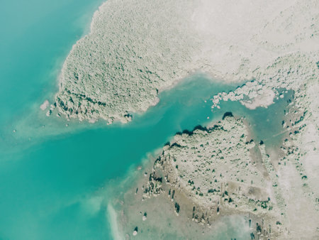 Aerial view on mountain lake. Drone over water reservoir at mountain valley covered with green spring forest. Beautiful view from above on smooth blue surface of mountain lake among highlands. Nobodyの写真素材
