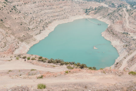 Woman travel portrait. Happy woman with long hair looking at camera and smiling. Close up portrait cute woman is posing on a heart shaped lake - travel destinationの写真素材