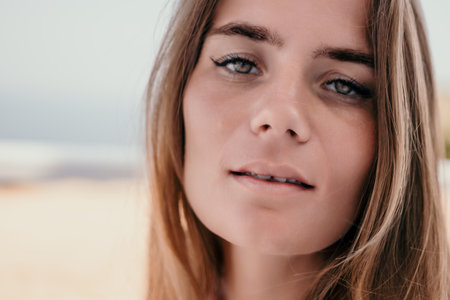 Happy woman portrait in cafe. Boho chic fashion style. Outdoor photo of young happy woman with long hair, sunny weather outdoors sitting in modern cafe.の写真素材