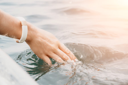 Woman in kayak back view. Happy young woman with long hair floating in transparent kayak on the crystal clear sea. Summer holiday vacation and cheerful female people relaxing having fun on the boatの写真素材