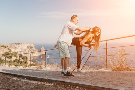 Happy Middle aged couple or friends practicing nordic walking in park near sea. Mature couple with...
