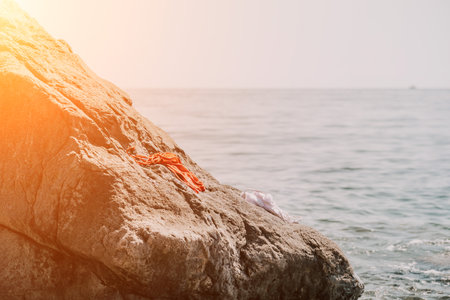 Woman summer sea. Happy woman swimming with inflatable donut on the beach in summer sunny day, surrounded by volcanic mountains. Summer vacation concept.の写真素材