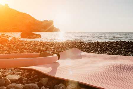 Pilates magic ring and rubber ball on yoga mat near sea. Female fitness yoga concept. Healthy lifestyle harmony and meditation.の写真素材
