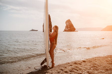 Woman sea sup. Close up portrait of happy young caucasian woman with long hair looking at camera and smiling. Cute woman portrait in bikini posing on sup board in the seaの写真素材
