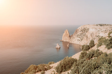 Aerial view from above on calm azure sea and volcanic rocky shores. Small waves on water surface in motion blur. Nature summer ocean sea beach background. Nobody. Holiday, vacation and travel conceptの写真素材