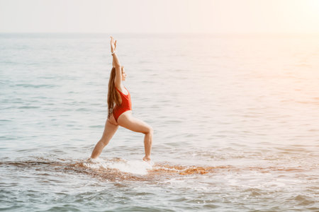 Woman sea yoga. Happy woman meditating in yoga pose on the beach, ocean and rock mountains....