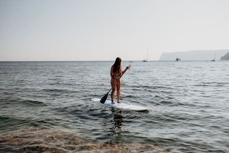 Woman sea sup. Close up portrait of happy young caucasian woman with long hair looking at camera and...