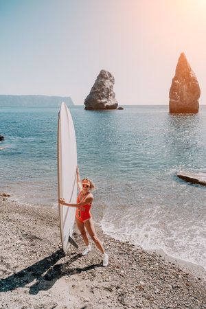 Woman sea sup. Close up portrait of happy young caucasian woman with blond hair looking at camera and smiling. Cute woman portrait in red bikini posing on sup board in the seaの写真素材