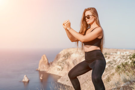 Fitness woman sea. Outdoor workout on yoga mat in park near to ocean beach. Female fitness pilates yoga routine concept. Healthy lifestyle. Happy fit woman exercising with rubber band in park.の写真素材