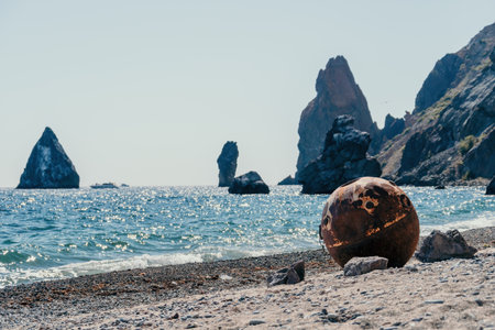 Old rusty sea mine on the beach.の写真素材