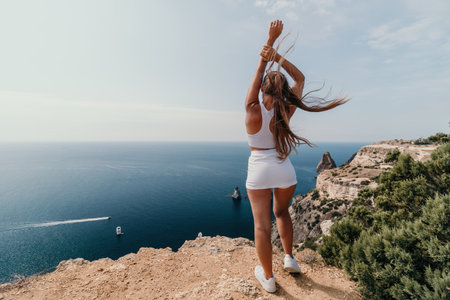 Woman sea pilates. Sporty middle-aged woman training in pilates on yoga mat by sea. concepts of health, wellness, and mindfulness in exercise, promoting the benefits of active and balanced lifestyleの写真素材