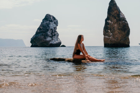 Woman summer travel sea. Happy tourist enjoy taking picture outdoors for memories. Woman traveler posing on the beach at sea surrounded by volcanic mountains, sharing travel adventure journeyの写真素材