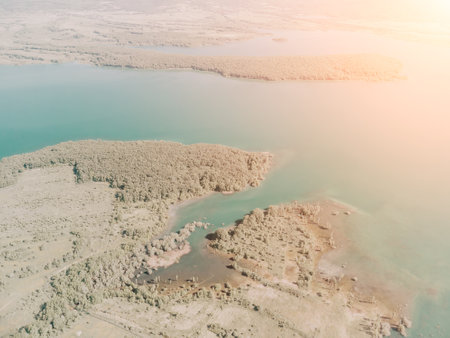 Aerial view on mountain lake. Drone over water reservoir at mountain valley covered with green spring forest. Beautiful view from above on smooth blue surface of mountain lake among highlands. Nobodyの写真素材
