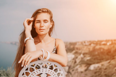 Happy boho woman portrait. Boho chic fashion style. Outdoor photo of free happy woman with long hair, sunny weather outdoors with sea mountains nature beautiful background.の写真素材
