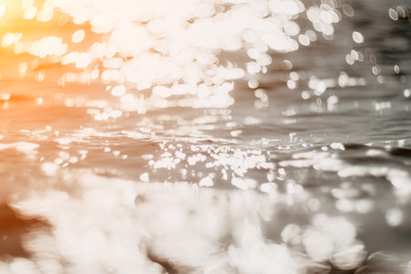 Abstract sea summer ocean sunset nature background. Small waves on golden water surface in motion...