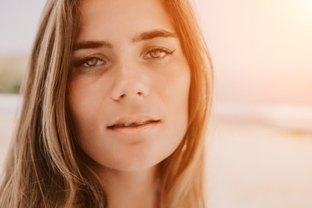 Happy woman portrait in cafe. Boho chic fashion style. Outdoor photo of young happy woman with long hair, sunny weather outdoors sitting in modern cafe.の写真素材