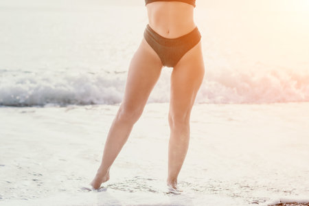 Woman summer travel sea. Happy woman enjoying her summer travels, captured in a lower body portrait, taking photos to preserve her memories of the scenic sea beach sharing travel adventure journeyの写真素材